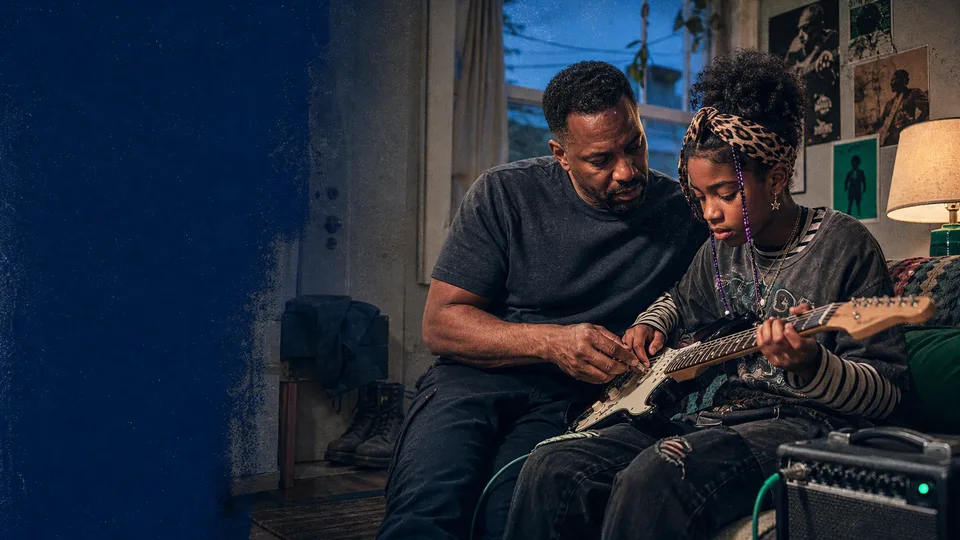 A parent sharing a guitar lesson with their child at home after work